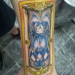 blue-ink-anime-tattoo-on-left-arm